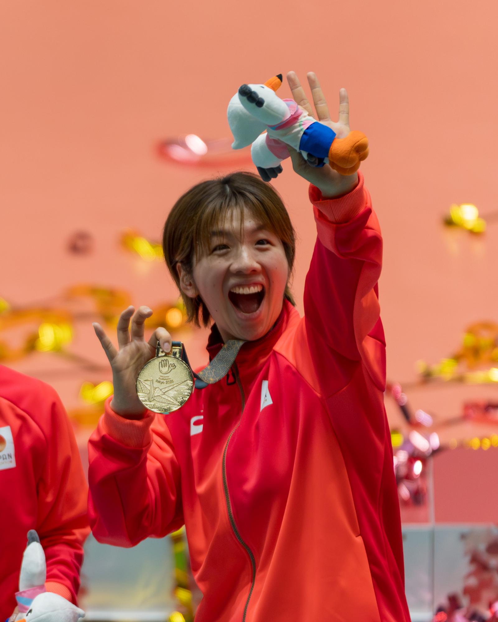 表彰式で退場をしながら2階席に向けて笑顔で手を振る尾塚選手の写真