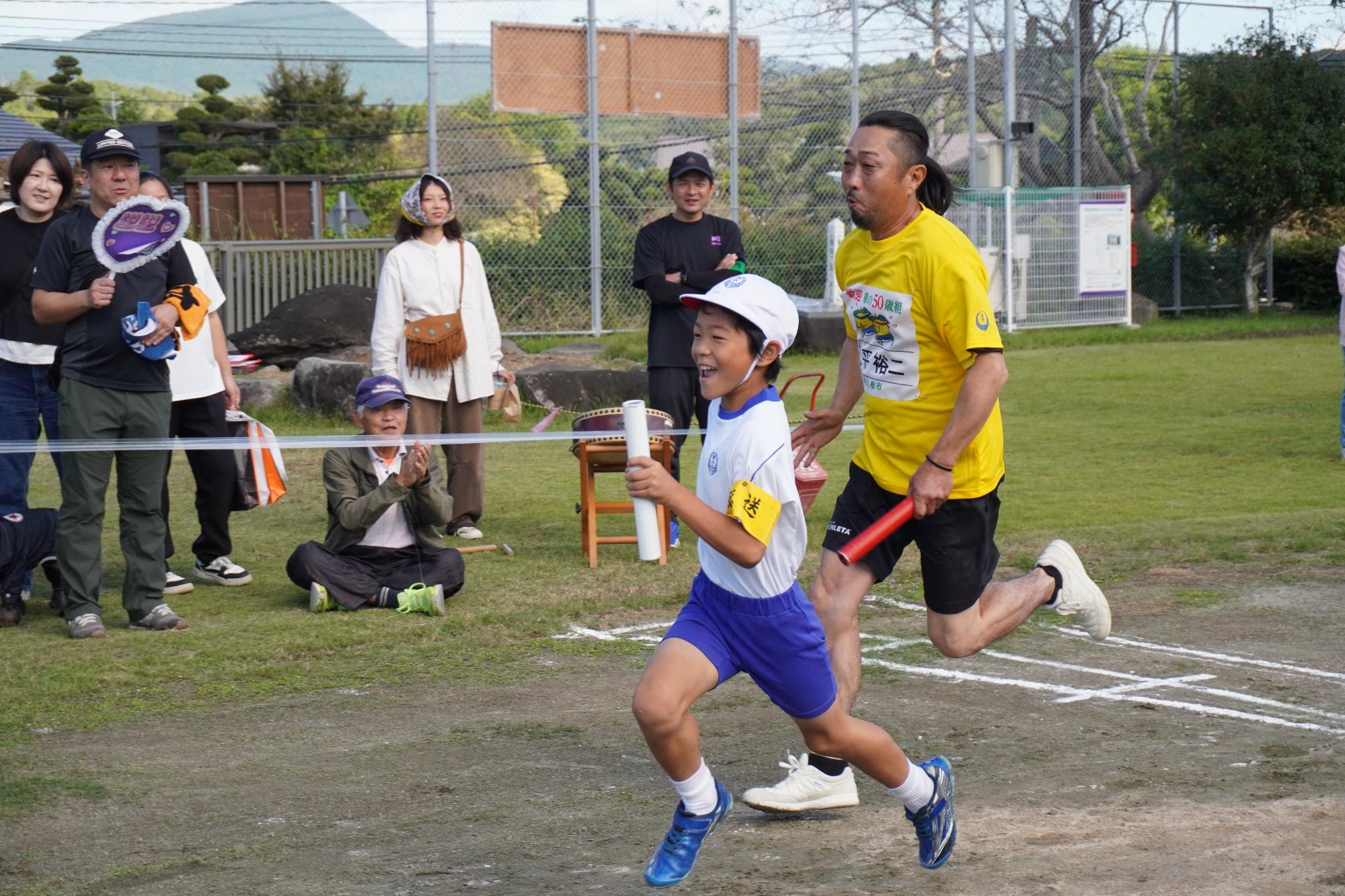 リレーで競い合う小学生と参加者の写真（その3）