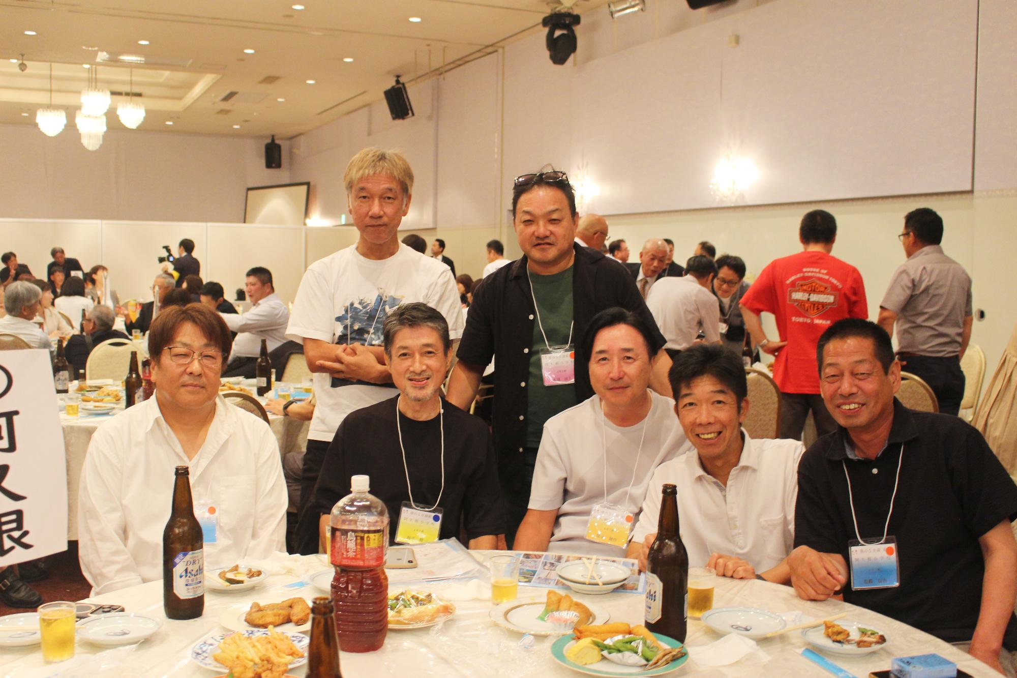 阿久根小出身の参加者たちの写真（テーブルを囲む7人の男性）