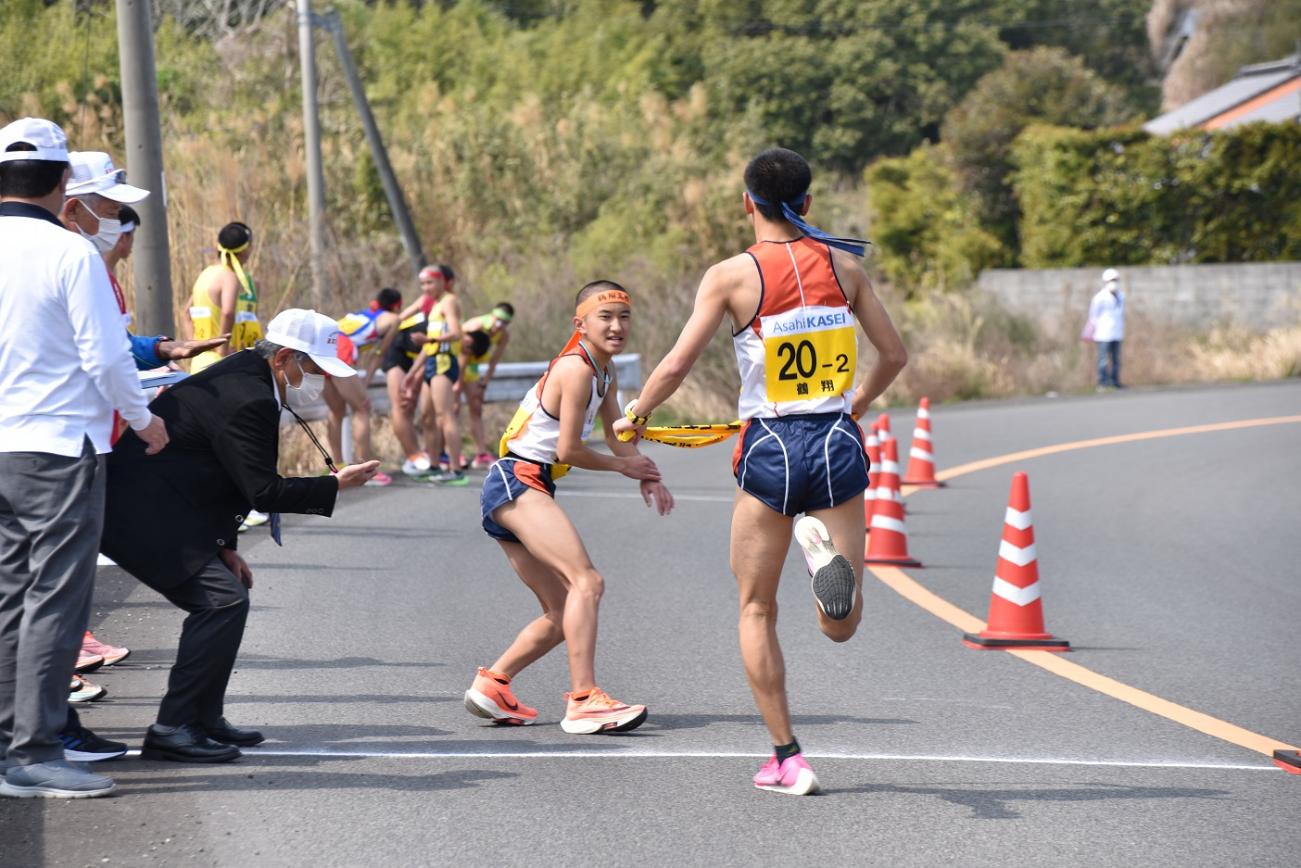 中継所で襷を繋ぐ男子選手たちの写真