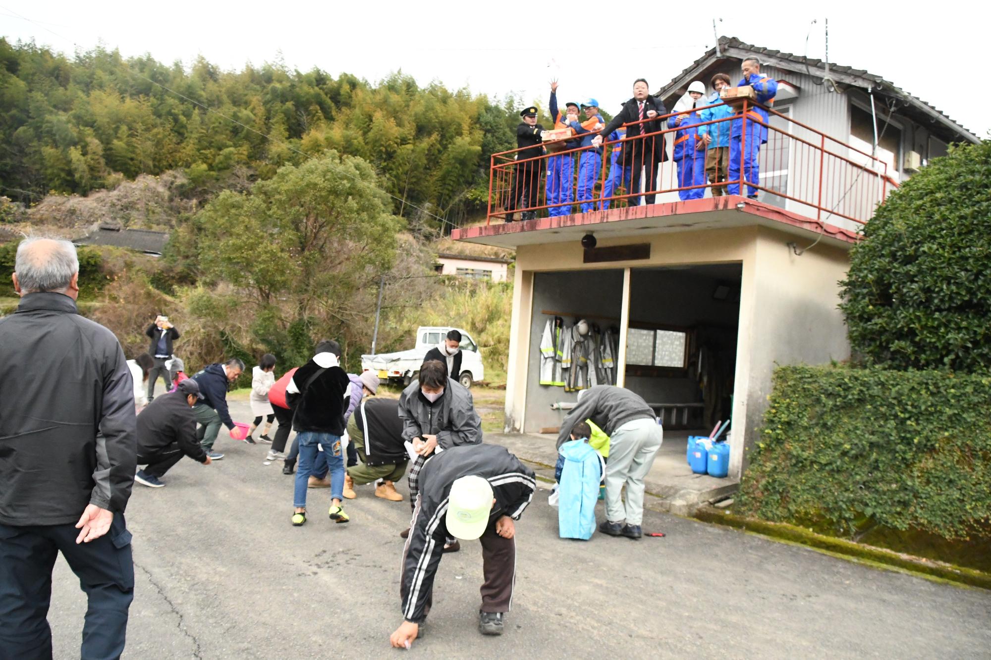 防水後に行われた餅投げの様子